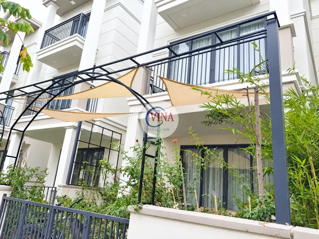 Mái bạt màu kem che hiên và cửa kính tầng trệt tại biệt thự Lavila
